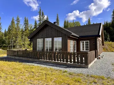 a small cabin with a wooden fence in a field at Beitobygda Getaway ,Nature And Luxury in Beitostøl