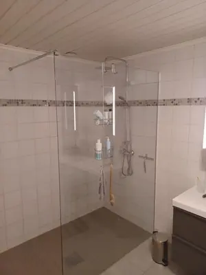 a shower with a glass door in a bathroom at Ski WM Trondheim in Melhus
