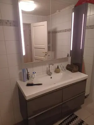 a bathroom with a sink and a mirror at Ski WM Trondheim in Melhus