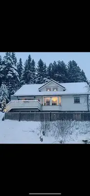 a house in the snow with a fence in front at Villa 10 min walk from Ski World Championship in Trondheim