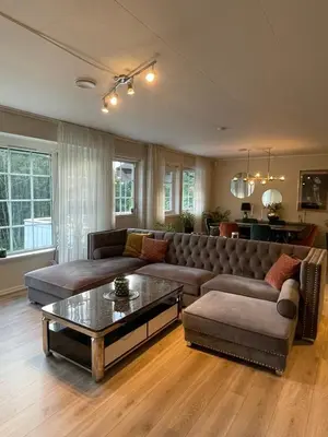 a living room with a couch and a coffee table at Villa 10 min walk from Ski World Championship in Trondheim