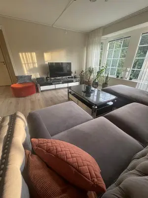 a living room with a couch and a table at Villa 10 min walk from Ski World Championship in Trondheim