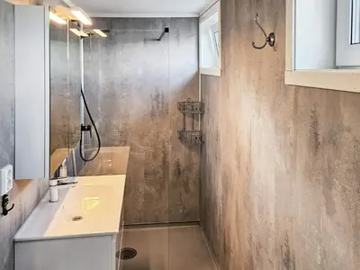 a bathroom with a shower and a sink at 4 person holiday home in Sørbøvåg in Sørbø