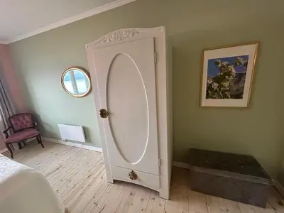 a bedroom with a white door with a mirror at Sognefjord Gjesteheim in Vangsnes
