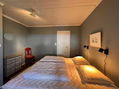a bedroom with a large bed with a ceiling at Mountain Home With 5 Bedrooms And 2 Fireplaces in Beitostøl