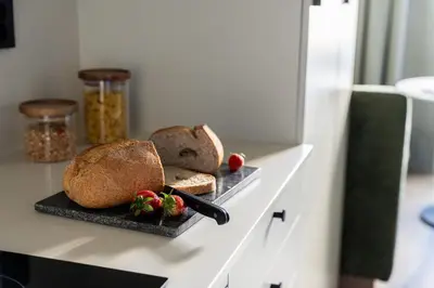 a table with two slices of bread and strawberries at VANDER Altona in Bergen