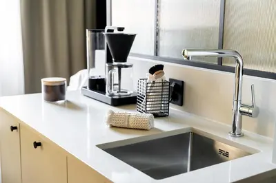 a kitchen counter with a sink and a mixer at VANDER Altona in Bergen