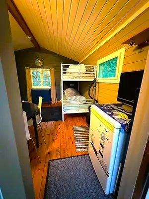 a small room with a bunk bed and a desk at Turifoss Camping Cabin 1 in Meråker