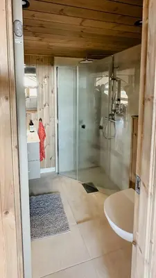 a bathroom with a shower and a sink and a toilet at Cozy Cabin With Fantastic Mountain Views In Oppheimåsen in Torpo