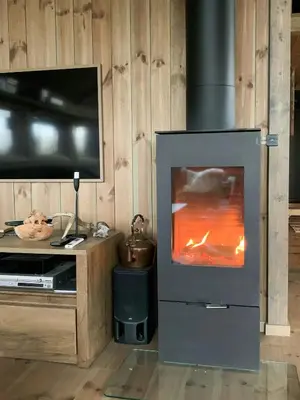 a living room with a fireplace and a tv at Cozy Cabin With Fantastic Mountain Views In Oppheimåsen in Torpo