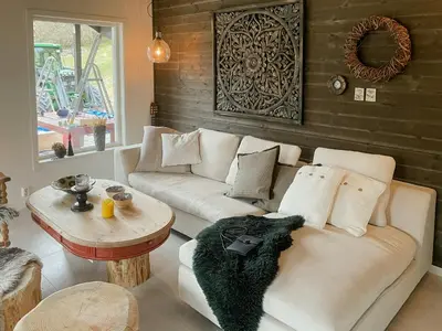 a living room with a white couch and a table at Cozy Modern Cabin In West Norway With View in Davik