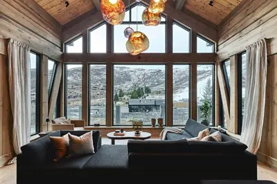 a living room with a couch and a large window at Luxury Cabin With Views in Stranda