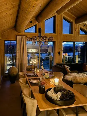 a dining room with a long wooden table and chairs at Modern Cabin With Beautiful Design By Gålåvatn in Gålå