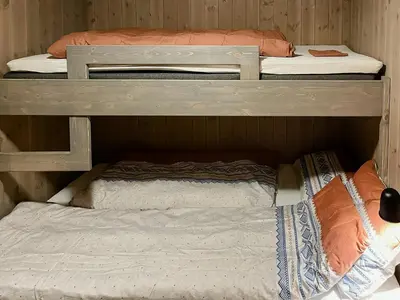 two bunk beds in a small room with a mattress at Modern Cabin With Beautiful Design By Gålåvatn in Gålå