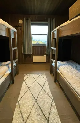 two bunk beds in a room with a window at Modern Cabin With Views Of Skeikampen in Svingvoll