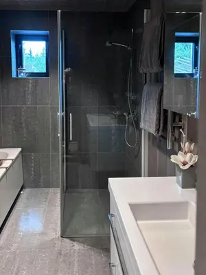 a bathroom with a glass shower and a sink at Modern Cabin With Views Of Skeikampen in Svingvoll