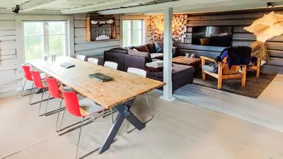 a living room with a table and a couch at Idyllic Log Cabin With Ski-Inout At Dagalifjell in Uvdal