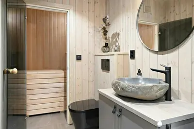 a bathroom with a bowl sink and a shower at Norefjell Cottage With Sauna And Whirlpool in Noresund
