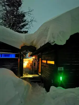 a building covered in snow with a green light at Ål Cabin With Panoramic Views in Favang