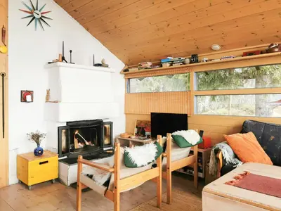 a living room with a couch and a fireplace at Ål Cabin With Panoramic Views in Favang