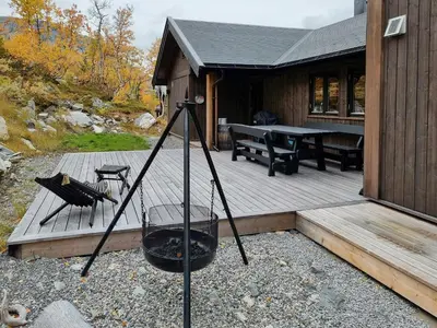 a wooden deck with a grill and a picnic table at Luxury Mountain Home With View On Gaustablikk in Rjukan