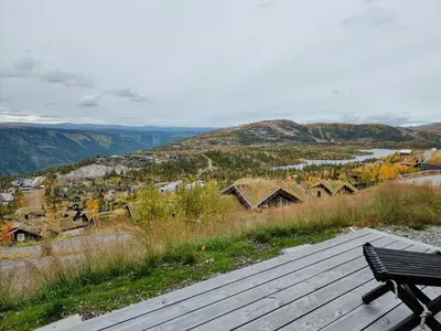 a bench sitting on top of a wooden deck at Luxury Mountain Home With View On Gaustablikk in Rjukan