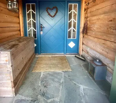 a blue front door with a heart sign on it at Charming Cabin Near Rondane National Park in Venabygd