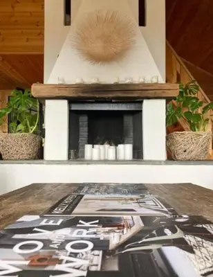 a fireplace on top of a table with a magazine at Authentic Cabin Hygge All Year Round At Hafjell in Øyer