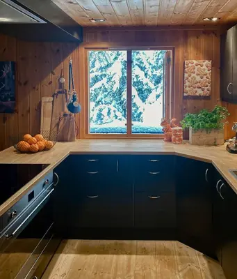 a kitchen with blue cabinets and a window at Authentic Cabin Hygge All Year Round At Hafjell in Øyer