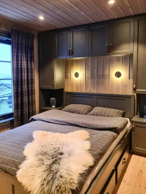 a bedroom with two beds with a furry rug on it at Modern Cabin With Ski Inout In Great Area in Brunstad