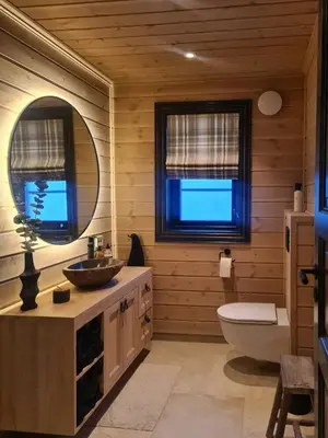 a bathroom with a sink and a toilet and a mirror at Modern Cabin With Ski Inout In Great Area in Brunstad