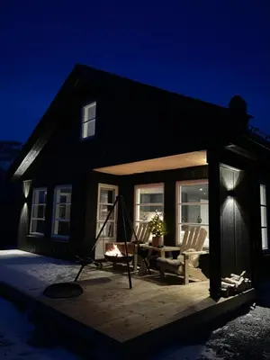 a house with a screened in porch at night at Modern Cabin By Hardangervidda in Garden