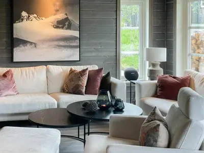 a living room with white couches and a table at Modern Cabin By Hardangervidda in Garden