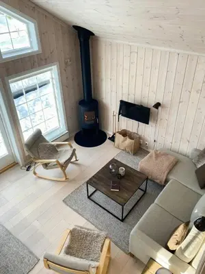 a living room with a couch and a fireplace at Relax By The Ski Tracks In A Cabin At Sjusjøen in Sjusjøen
