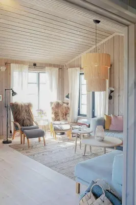 a living room with couches and tables and windows at Secluded Mountain Cabin In Rauland With View in Brunstad