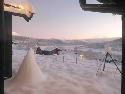 a view from a window of a snow covered house at Secluded Mountain Cabin In Rauland With View in Brunstad