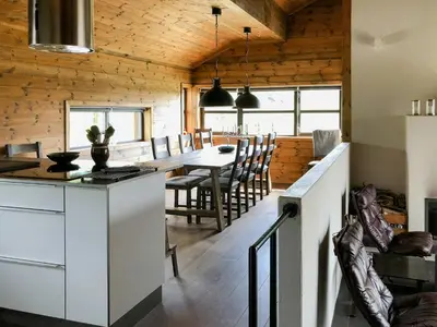 a kitchen and dining room with a table and chairs at Cozy Holiday Home Embraced By Valdres Hills in Vang I Valdres