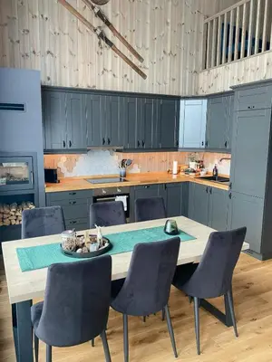 a kitchen with a table and chairs in a kitchen at Modern Cabin In Trysil With Mountain Views in Trysil
