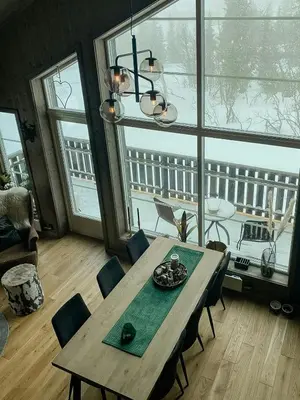 a dining room table with chairs and a chandelier at Modern Cabin In Trysil With Mountain Views in Trysil