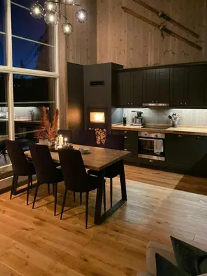 a kitchen and dining room with a table and chairs at Modern Cabin In Trysil With Mountain Views in Trysil