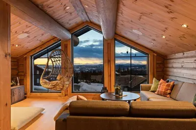 a living room with a couch and a large window at Modern And Spacious Cabin At Mosetertoppen in Øyer