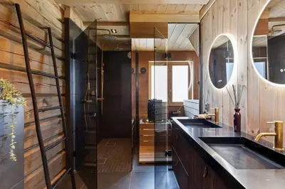 a bathroom with wooden walls and a sink at Modern And Spacious Cabin At Mosetertoppen in Øyer