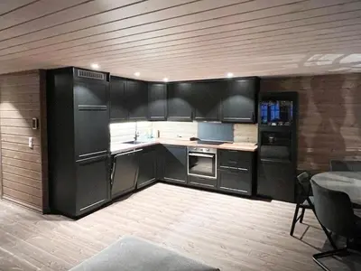 a kitchen with black cabinets and a table in a room at Mountain Cabin With Panoramic View In Nesbyen in Nesbyen