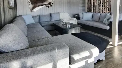 a living room with a couch and a table at Simple Cabin Life In This Nature Cabin in Uvdal