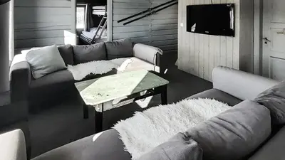 a living room with a couch and a table at Simple Cabin Life In This Nature Cabin in Uvdal
