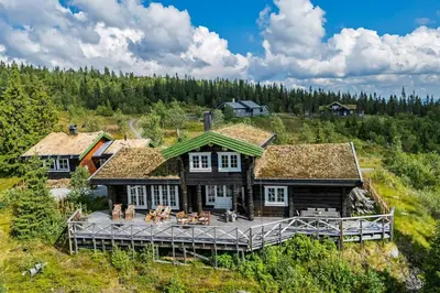 an aerial view of a log house with a deck at Cozy And Spacious Family Cabin In Valdres in Bagn