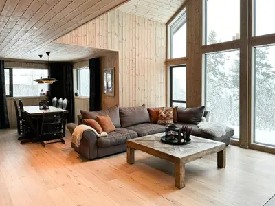 a living room with a couch and a table at Modern Mountain Home At Nerskogen, Trollheimen in Nerskogen