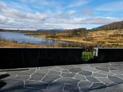 a patio with a view of a body of water at Large Cabin By Farhovdtjønn In Rauland in Rauland