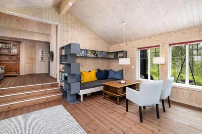 a living room with a couch and a table and chairs at Family Cabin With Panoramic View Near Vikerfjellet in Hønefoss