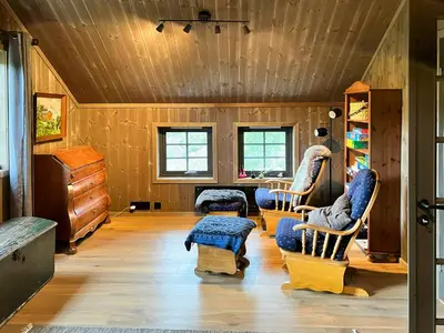 a living room with wooden walls and wooden floors at Modern Family Cabin At Vegglifjell in Veggli